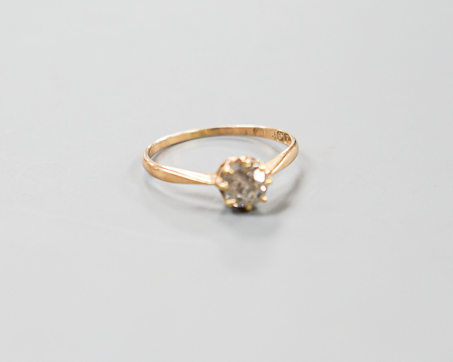 A George V 18ct gold and claw set solitaire diamond ring, size N/O, gross 1.6 grams.